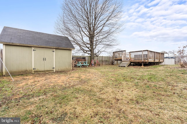 view of yard with a deck and a shed