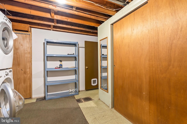 basement featuring stacked washer / dryer