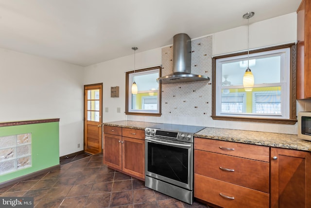 kitchen with pendant lighting, decorative backsplash, stainless steel range with electric cooktop, and wall chimney exhaust hood