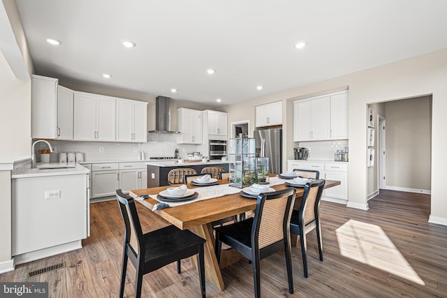 dining area with dark hardwood / wood-style flooring and sink