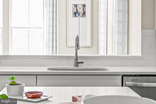 details featuring white cabinetry, sink, and stainless steel dishwasher