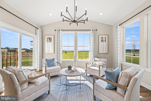 sunroom / solarium with lofted ceiling, plenty of natural light, and a chandelier