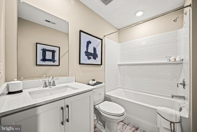 full bathroom with tiled shower / bath, vanity, and toilet