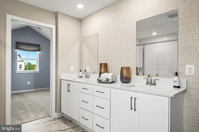 bathroom with vanity and a shower with door