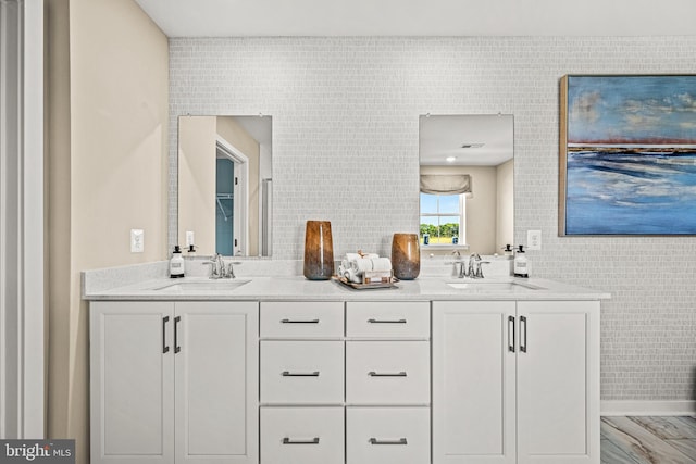 bathroom featuring vanity and tile walls