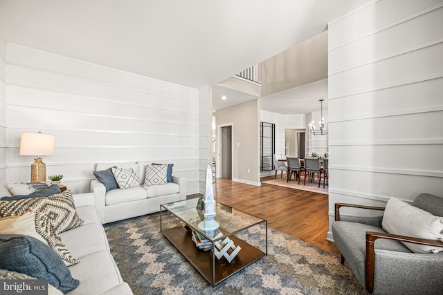 living room featuring hardwood / wood-style floors and an inviting chandelier