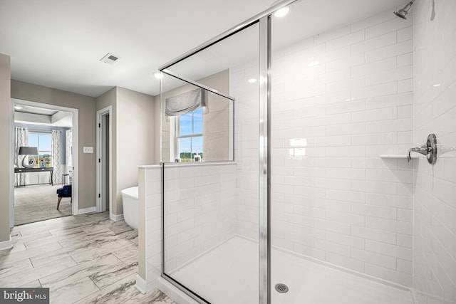 bathroom with a shower with door