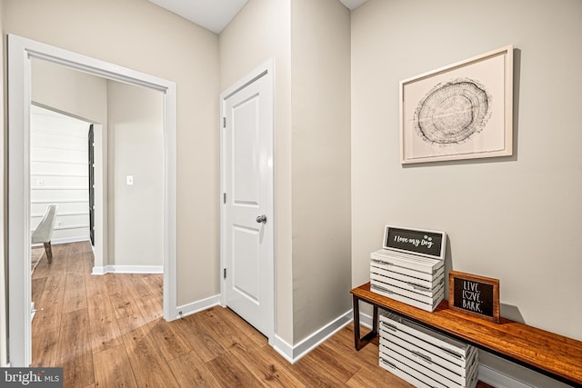 hallway with light hardwood / wood-style flooring