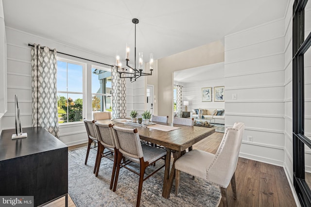 dining room with dark wood-type flooring and a chandelier