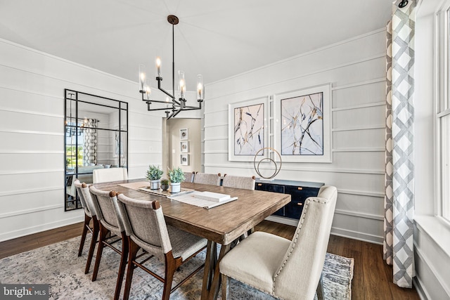 dining space with dark hardwood / wood-style floors and a chandelier