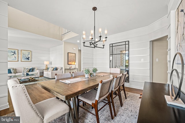 dining room with wood-type flooring and a chandelier