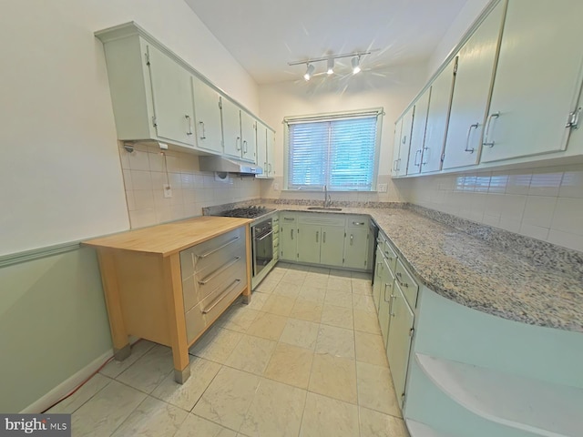 kitchen featuring sink, backsplash, oven, and black gas cooktop