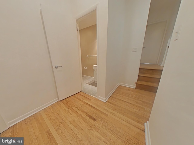 hallway with light hardwood / wood-style floors