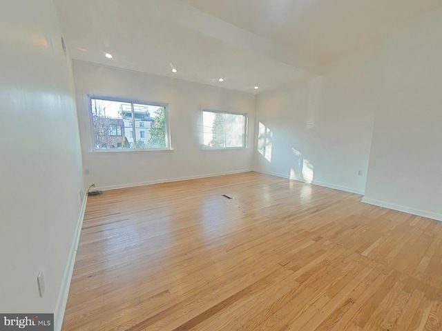 empty room with light hardwood / wood-style flooring