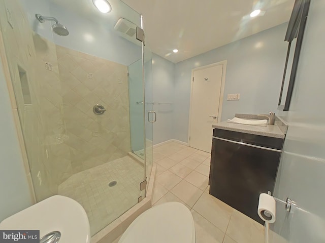 bathroom featuring walk in shower, vanity, toilet, and tile patterned flooring