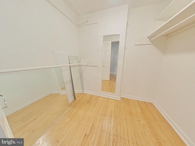 spacious closet with light hardwood / wood-style floors