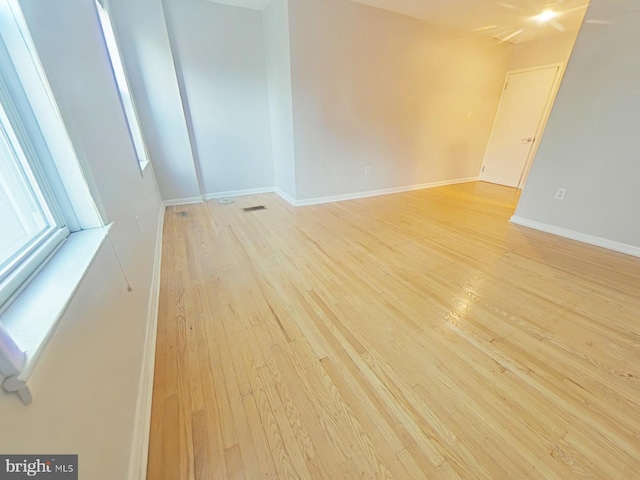 empty room with light hardwood / wood-style floors