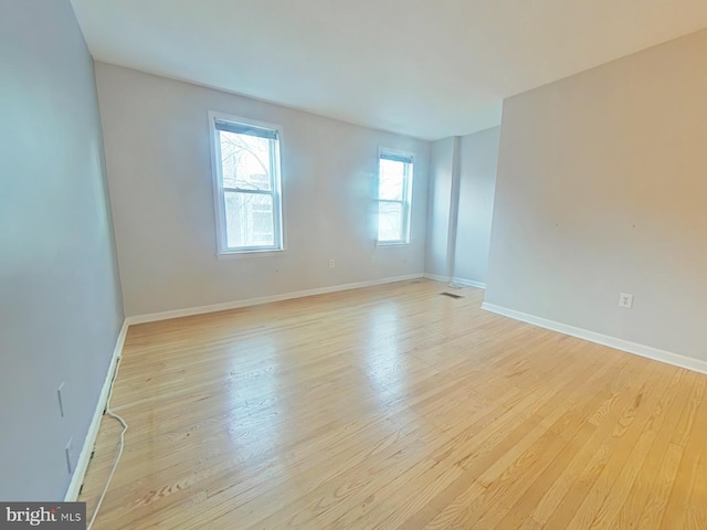 empty room with light hardwood / wood-style floors