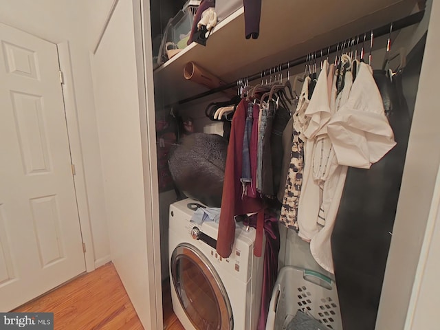 laundry room featuring washer / dryer and light hardwood / wood-style floors