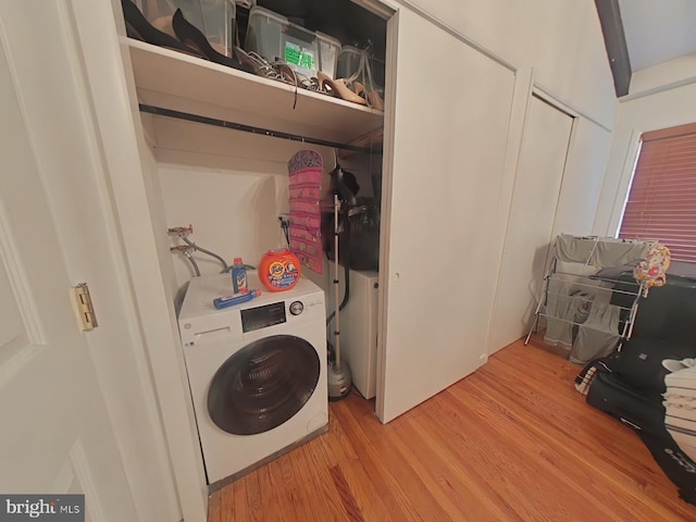 laundry area featuring washer / clothes dryer and light hardwood / wood-style floors