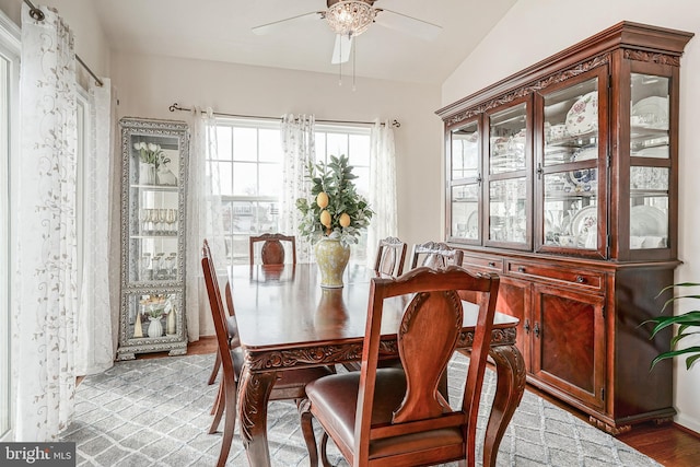 dining area featuring light hardwood / wood-style flooring, vaulted ceiling, and ceiling fan