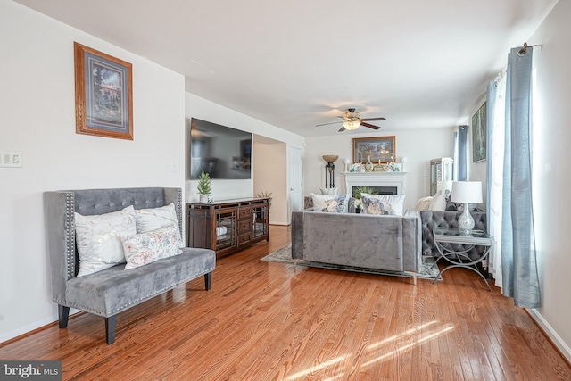 living room with hardwood / wood-style floors and ceiling fan