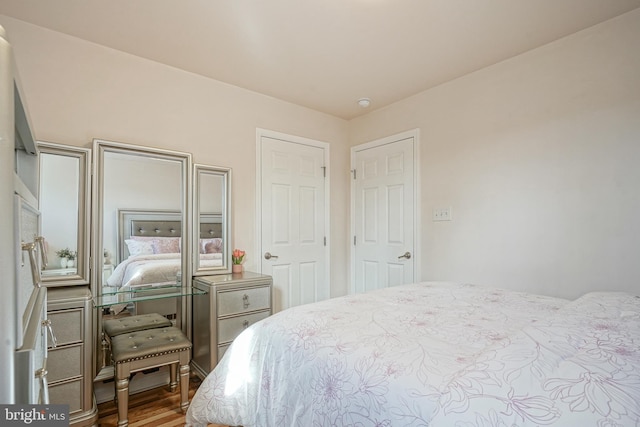 bedroom with hardwood / wood-style floors