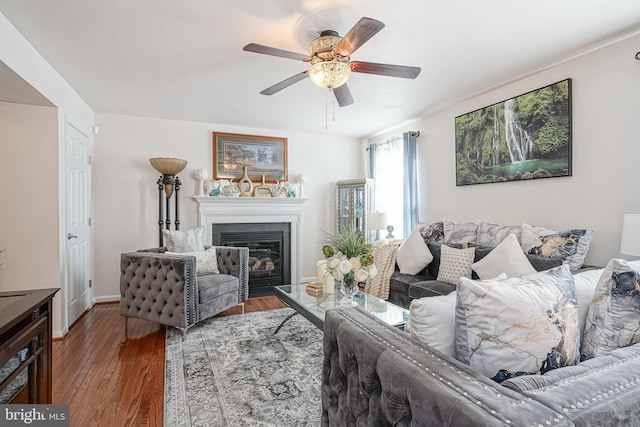 living room featuring dark hardwood / wood-style flooring and ceiling fan