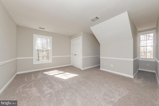 bonus room with carpet flooring, visible vents, and baseboards