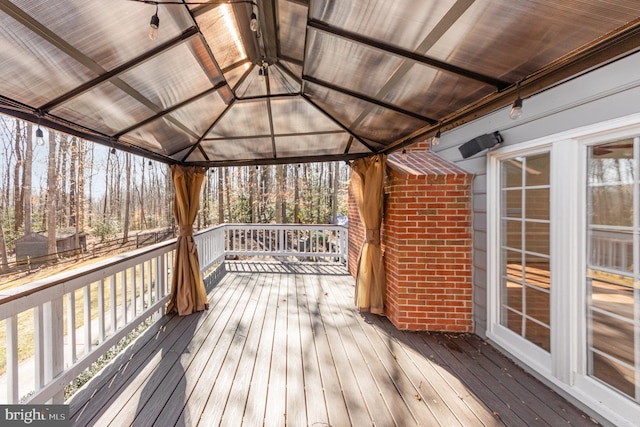 wooden terrace featuring a gazebo