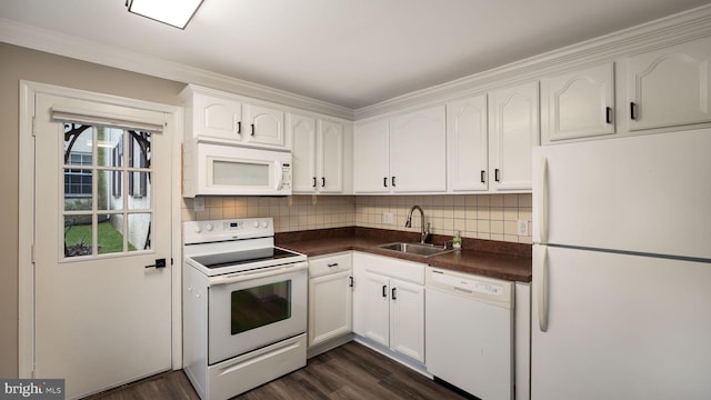 kitchen featuring sink, white appliances, white cabinets, and backsplash