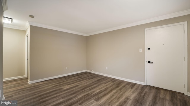 empty room with crown molding and dark hardwood / wood-style floors