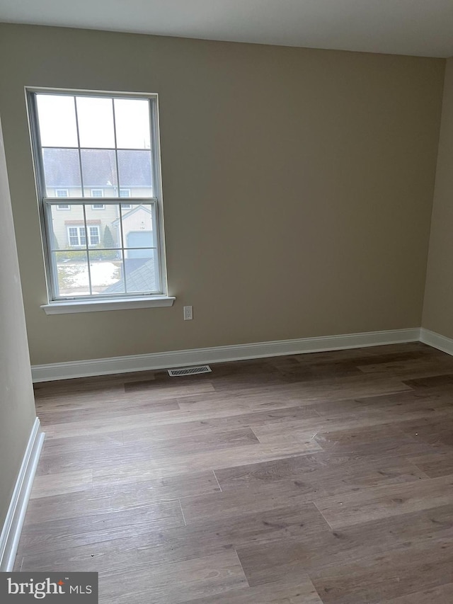 spare room featuring light hardwood / wood-style flooring