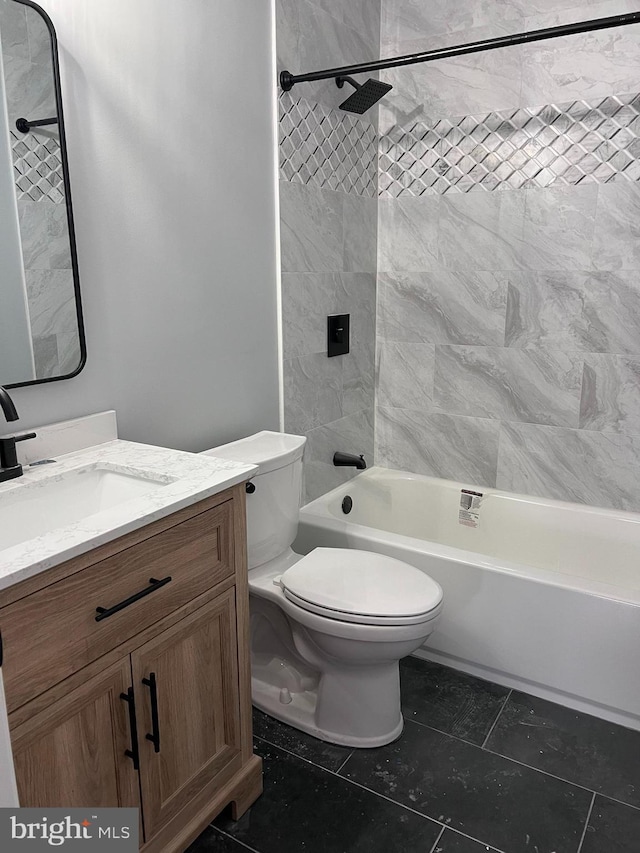 full bathroom featuring vanity, toilet, tile patterned floors, and tiled shower / bath