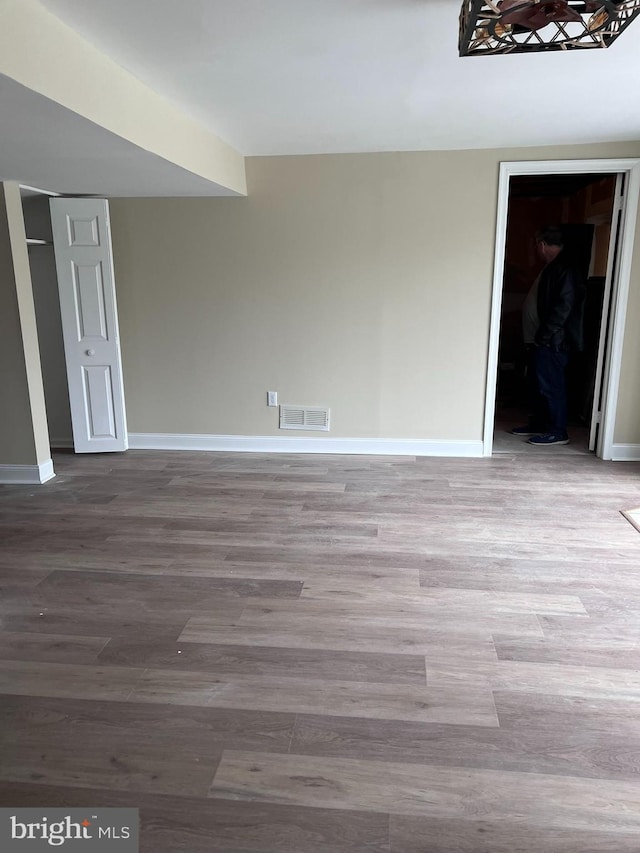 unfurnished room with hardwood / wood-style floors