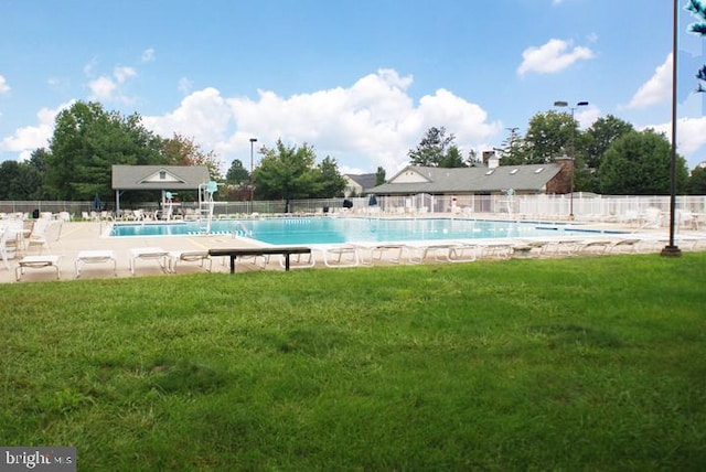 view of pool featuring a yard and a patio area