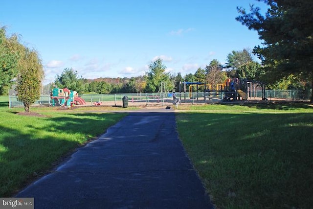 view of community featuring a playground and a yard