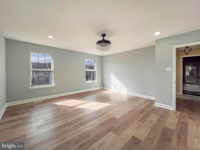 unfurnished room with wood-type flooring