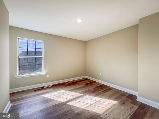 empty room with light hardwood / wood-style flooring