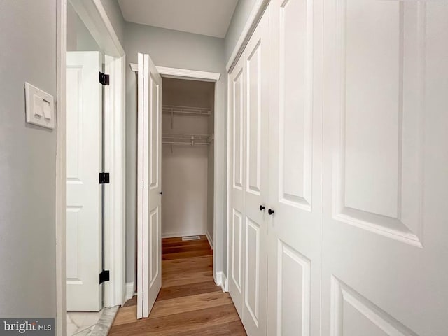 corridor featuring light hardwood / wood-style flooring