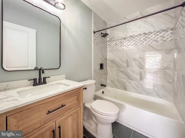 full bathroom with tile patterned floors, vanity, toilet, and tiled shower / bath combo