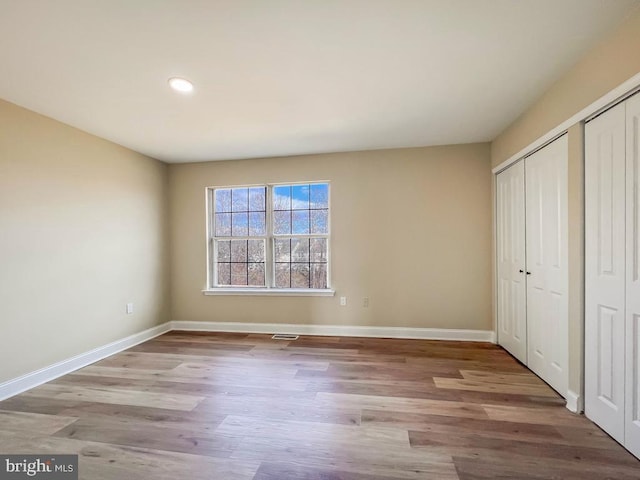 unfurnished bedroom with light hardwood / wood-style floors and a closet