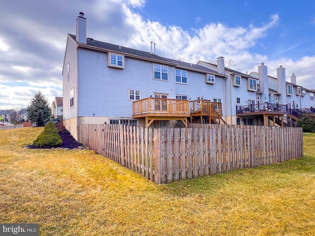 rear view of house with a wooden deck, a yard, and a wall mounted air conditioner