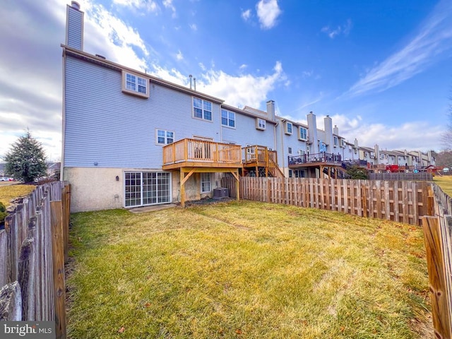 back of property with a wooden deck, a yard, and central air condition unit