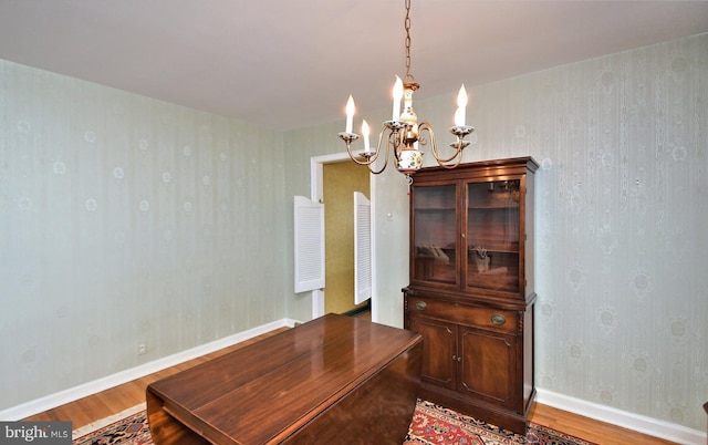 dining room featuring hardwood / wood-style flooring and a notable chandelier