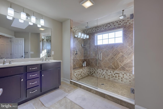 bathroom featuring a sink, tile patterned flooring, a shower stall, and double vanity