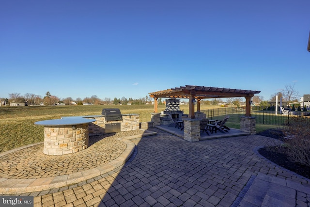 view of patio / terrace featuring an outdoor kitchen, a pergola, grilling area, and fence