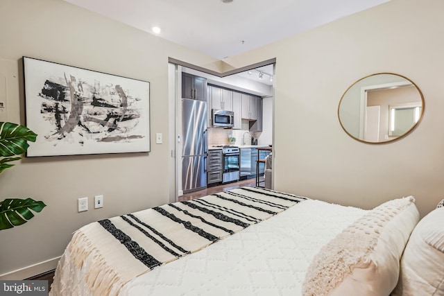 bedroom featuring stainless steel fridge and sink