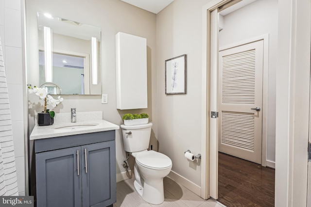 bathroom with vanity, wood-type flooring, and toilet