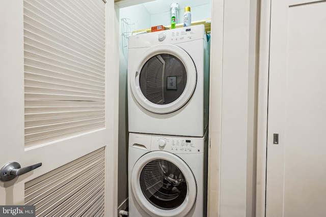 laundry room featuring stacked washer and clothes dryer